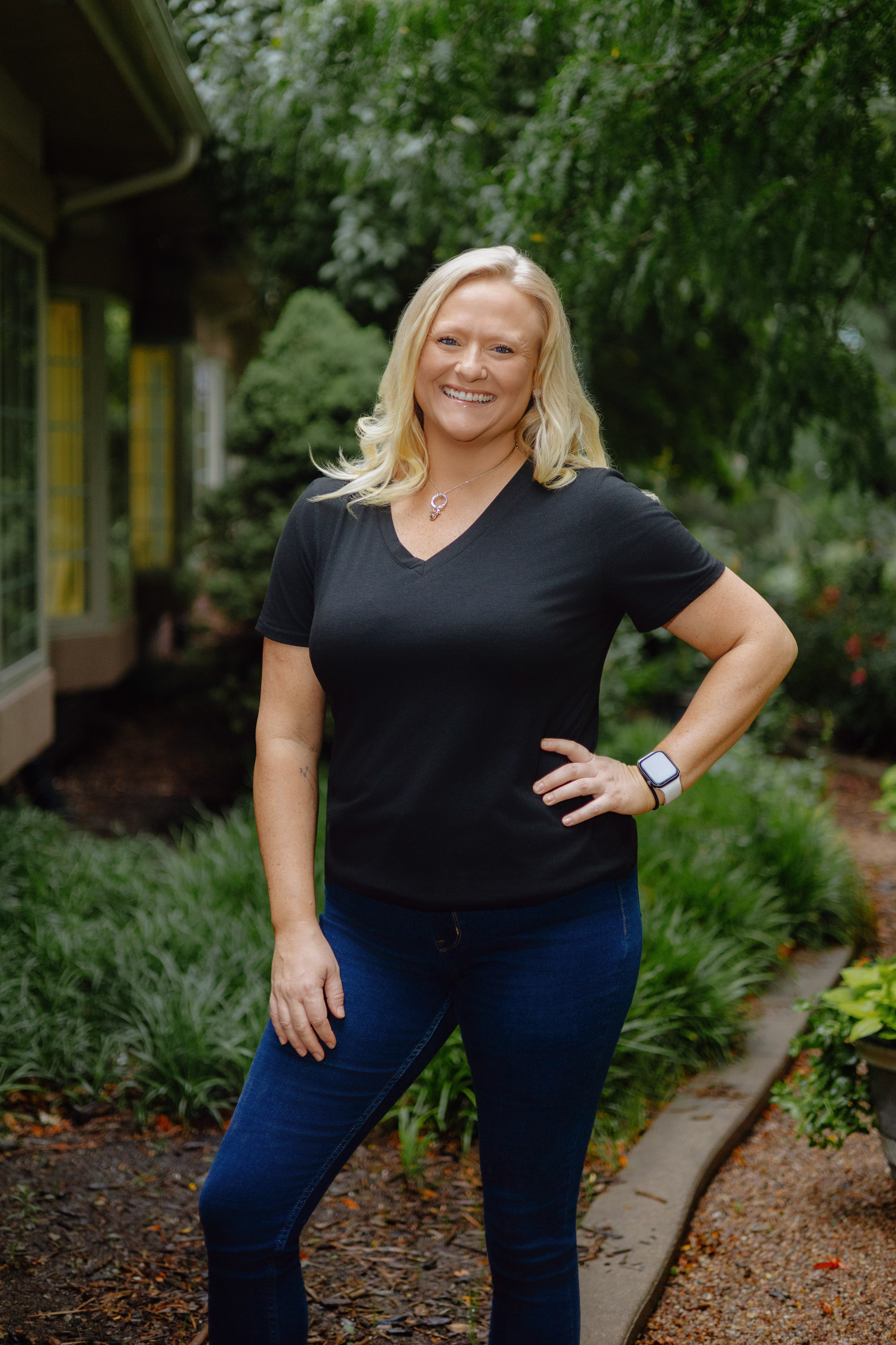 Staff headshot of a blonde woman, photographed outdoors