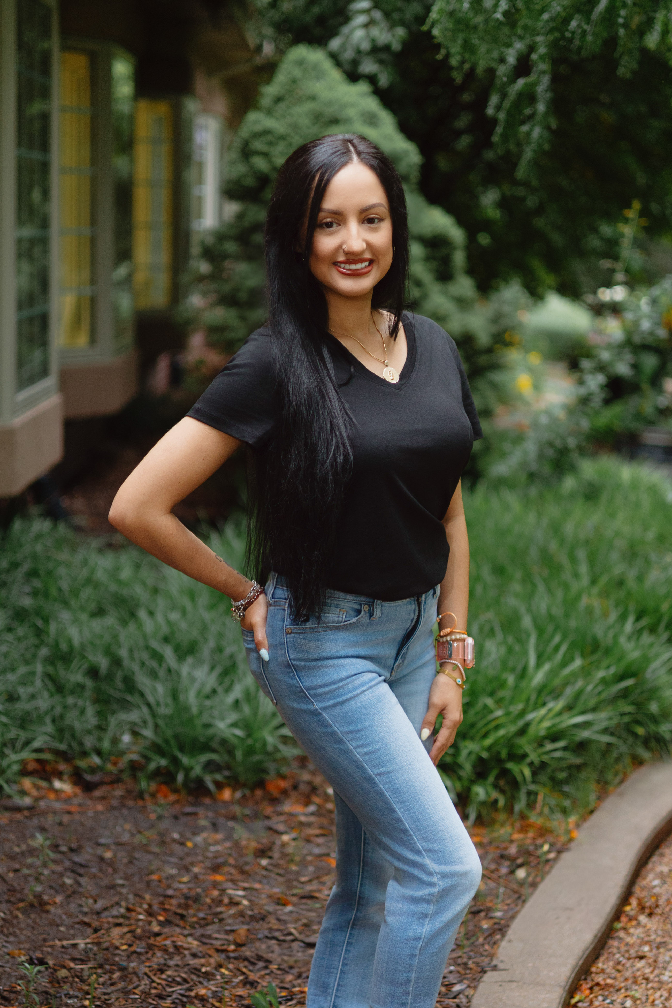 Staff headshot of a woman with long dark hair, photographed outdoors